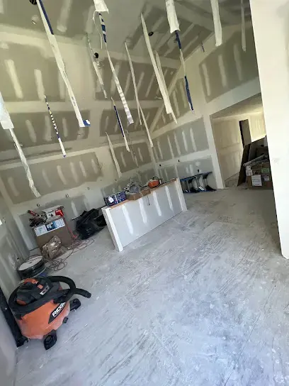 Room stripped back to bare drywall with a shop vacuum on the floor during Downingtown water damage repairs