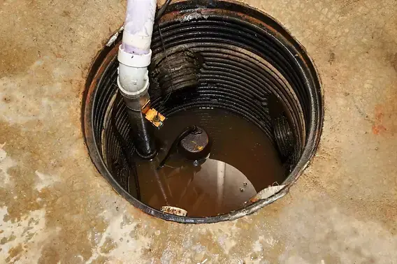 Sump pump failure in Downingtown, PA: a basement sump pit filled with water around the pump